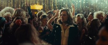 Movie still from “Borg vs. McEnroe” (2017), directed by Janus Metz – A crowd of people in a room with lights; Medium shot, Over the shoulder angle