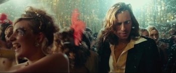 Movie still from “Borg vs. McEnroe” (2017), directed by Janus Metz – A crowd of people in a room with lights; Medium shot, Over the shoulder angle