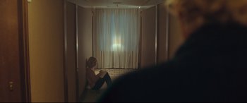 Movie still from “Borg vs. McEnroe” (2017), directed by Janus Metz – A woman sitting on a bed in front of a window; Medium shot, Over the shoulder angle