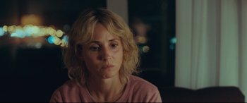 Movie still from “Borg vs. McEnroe” (2017), directed by Janus Metz – A woman sitting in front of a window looking sad; Close Up shot, Over the shoulder angle