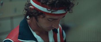 Movie still from “Borg vs. McEnroe” (2017), directed by Janus Metz – A person wearing a headband; Close Up shot, High angle
