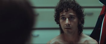 Movie still from “Borg vs. McEnroe” (2017), directed by Janus Metz – A person with curly hair in a room; Close Up shot, Over the shoulder angle