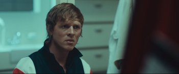 Movie still from “Borg vs. McEnroe” (2017), directed by Janus Metz – A man looking into a mirror in a room; Close Up shot, Over the shoulder angle