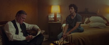 Movie still from “Borg vs. McEnroe” (2017), directed by Janus Metz – Two people sitting in a living room playing chess; Medium shot, Over the shoulder angle