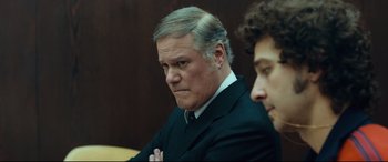 Movie still from “Borg vs. McEnroe” (2017), directed by Janus Metz – A man in a suit and tie sitting next to another man in a suit and tie; Close Up shot, Over the shoulder angle