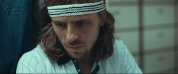 Movie still from “Borg vs. McEnroe” (2017), directed by Janus Metz – A person with long hair wearing a headband; Close Up shot, Low angle