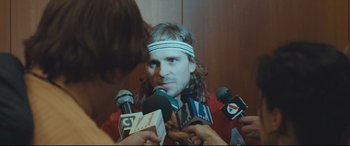 Movie still from “Borg vs. McEnroe” (2017), directed by Janus Metz – A man is being interviewed by a bunch of reporters; Close Up shot, Over the shoulder angle