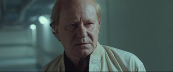 Movie still from “Borg vs. McEnroe” (2017), directed by Janus Metz – An old man with a goatee looking angry; Close Up shot, Over the shoulder angle