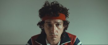 Movie still from “Borg vs. McEnroe” (2017), directed by Janus Metz – A person with curly hair wearing a headband; Close Up shot, Low angle