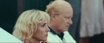 Movie still from “Borg vs. McEnroe” (2017), directed by Janus Metz – A woman sitting next to an older man in a room; Close Up shot, Over the shoulder angle