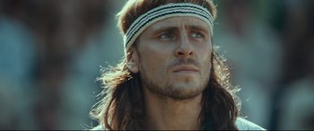 Movie still from “Borg vs. McEnroe” (2017), directed by Janus Metz – A person with long hair wearing a headband; Close Up shot, Low angle