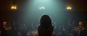 Movie still from “Borg vs. McEnroe” (2017), directed by Janus Metz – A group of people sitting around a table in a dark room; Medium shot, Over the shoulder angle
