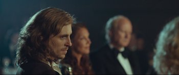 Movie still from “Borg vs. McEnroe” (2017), directed by Janus Metz – A man and a woman and an older man in tuxedos; Close Up shot, Over the shoulder angle