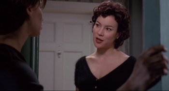 Movie still from “Bound” (1996), directed by Lilly Wachowski – A woman in a black dress talking to a man; Close Up shot, Over the shoulder angle