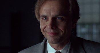 Movie still from “Bound” (1996), directed by Lilly Wachowski – A person wearing a suit and tie; Close Up shot, Low angle