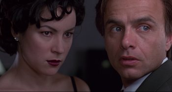 Movie still from “Bound” (1996), directed by Lilly Wachowski – A man and a woman standing next to each other; Close Up shot, Low angle