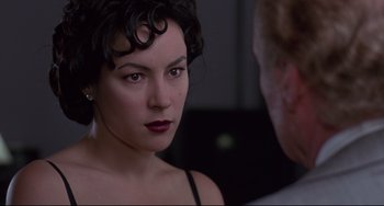 Movie still from “Bound” (1996), directed by Lilly Wachowski – A person wearing a black top; Close Up shot, Over the shoulder angle