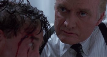 Movie still from “Bound” (1996), directed by Lilly Wachowski – An older man and a younger man are looking at each other; Close Up shot, Over the shoulder angle