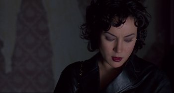 Movie still from “Bound” (1996), directed by Lilly Wachowski – A person wearing a leather jacket; Close Up shot, High angle