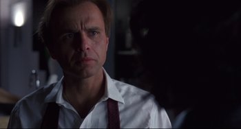 Movie still from “Bound” (1996), directed by Lilly Wachowski – A person wearing a shirt and tie; Close Up shot, Low angle