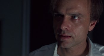 Movie still from “Bound” (1996), directed by Lilly Wachowski – A person looking at the camera; Close Up shot, Low angle