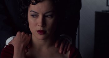 Movie still from “Bound” (1996), directed by Lilly Wachowski – A woman with her arms wrapped around her shoulder; Close Up shot, Over the shoulder angle