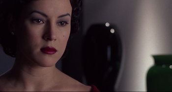 Movie still from “Bound” (1996), directed by Lilly Wachowski – A person wearing a red dress; Close Up shot, Over the shoulder angle