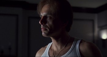 Movie still from “Bound” (1996), directed by Lilly Wachowski – A person wearing a white shirt; Close Up shot, Low angle