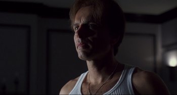 Movie still from “Bound” (1996), directed by Lilly Wachowski – A person wearing a white shirt; Close Up shot, Low angle