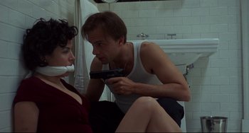 Movie still from “Bound” (1996), directed by Lilly Wachowski – A man and a woman sitting on the floor in front of a sink; Medium shot, High angle