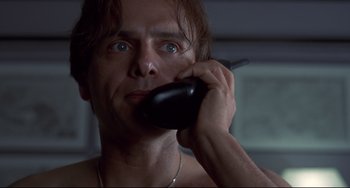 Movie still from “Bound” (1996), directed by Lilly Wachowski – A person talking on a cell phone; Close Up shot, Low angle
