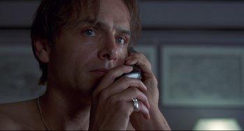 Movie still from “Bound” (1996), directed by Lilly Wachowski – A person talking on a cell phone; Close Up shot, Low angle