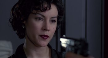 Movie still from “Bound” (1996), directed by Lilly Wachowski – A person holding a gun; Close Up shot, Over the shoulder angle