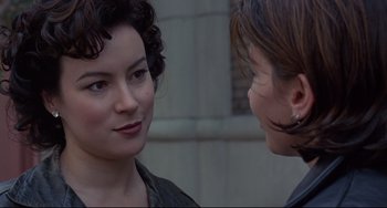 Movie still from “Bound” (1996), directed by Lilly Wachowski – Two women talking to each other in front of a building; Close Up shot, Over the shoulder angle