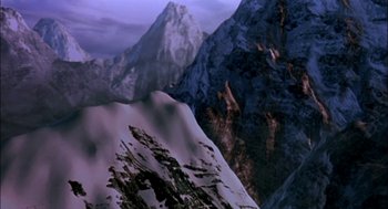 Movie still from “Bowling for Columbine” (2002), directed by Michael Moore – A mountain range with a snow covered peak in the background; Extreme Wide shot, High angle