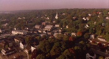 Movie still from “Bowling for Columbine” (2002), directed by Michael Moore – An aerial view of a small town with a church in the background; Extreme Wide shot, High angle