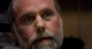 Movie still from “Bowling for Columbine” (2002), directed by Michael Moore – A person with a beard; Close Up shot, High angle