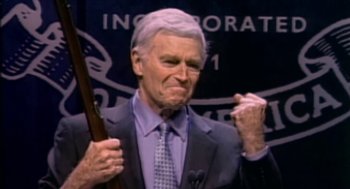 Movie still from “Bowling for Columbine” (2002), directed by Michael Moore – An older man in a suit holding a rifle; Close Up shot, Low angle