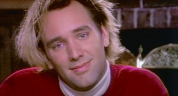 Movie still from “Bowling for Columbine” (2002), directed by Michael Moore – A man with blonde hair and wearing a red shirt; Extreme Close Up shot, Over the shoulder angle