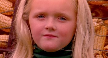 Movie still from “Bowling for Columbine” (2002), directed by Michael Moore – A young girl's face with long blonde hair; Close Up shot, Low angle