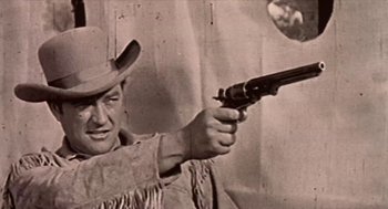 Movie still from “Bowling for Columbine” (2002), directed by Michael Moore – An old black and white photo of a man holding a gun; Close Up shot, Low angle