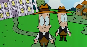 Movie still from “Bowling for Columbine” (2002), directed by Michael Moore – Two cartoon characters are standing in a field; Medium shot, Low angle