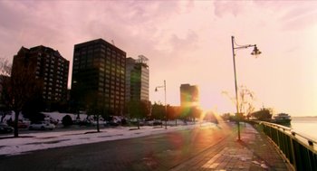 Movie still from “Bowling for Columbine” (2002), directed by Michael Moore – The sun is setting over a city street; Extreme Wide shot, Low angle