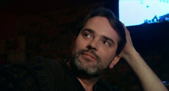 Movie still from “Bowling for Columbine” (2002), directed by Michael Moore – A person with a beard; Close Up shot, Low angle