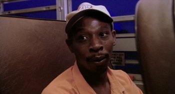 Movie still from “Bowling for Columbine” (2002), directed by Michael Moore – A person wearing a hat; Close Up shot, High angle