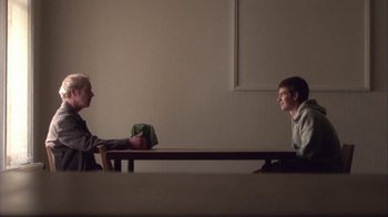 Movie still from “Boy A” (2007), directed by John Crowley – Two people sitting at a table talking to each other; Wide shot, Over the shoulder angle