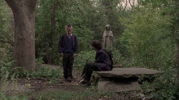 Movie still from “Boy A” (2007), directed by John Crowley – Two people are sitting on a bench in the woods; Wide shot, Over the shoulder angle