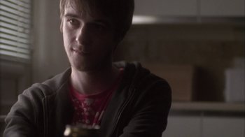 Movie still from “Boy A” (2007), directed by John Crowley – A young man is sitting in a dark room; Close Up shot, Over the shoulder angle