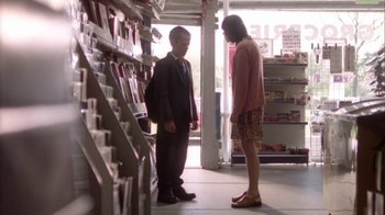 Movie still from “Boy A” (2007), directed by John Crowley – A man and a woman standing next to each other in a store; Wide shot, Low angle