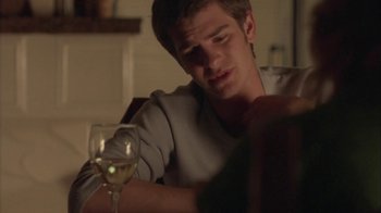 Movie still from “Boy A” (2007), directed by John Crowley – A man sitting at a table with a glass of wine; Close Up shot, Over the shoulder angle